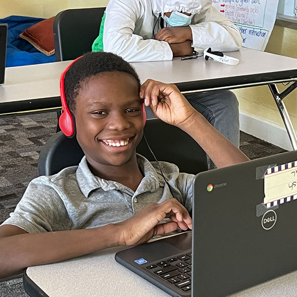 Student on laptop with headphones