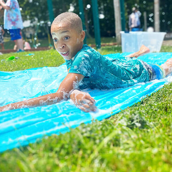 boy student on water slide