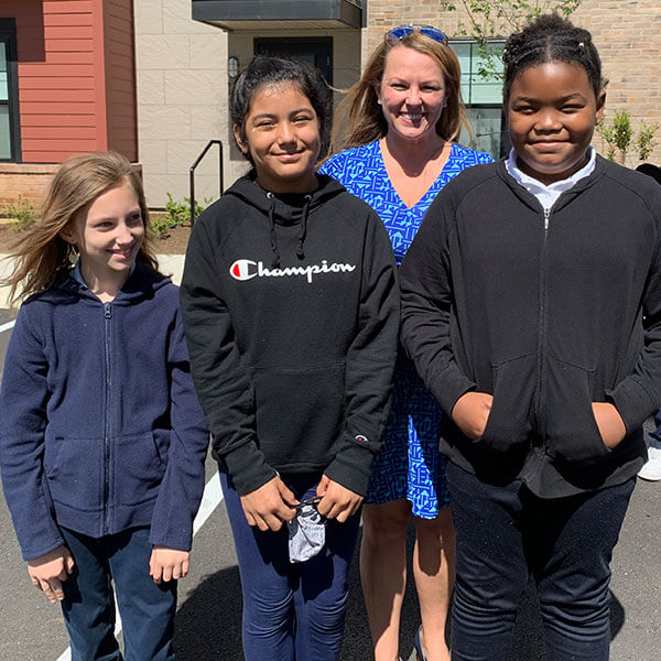 students with teacher outside smiling