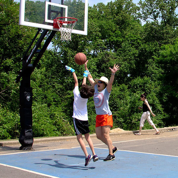 teacher and student playing basketball