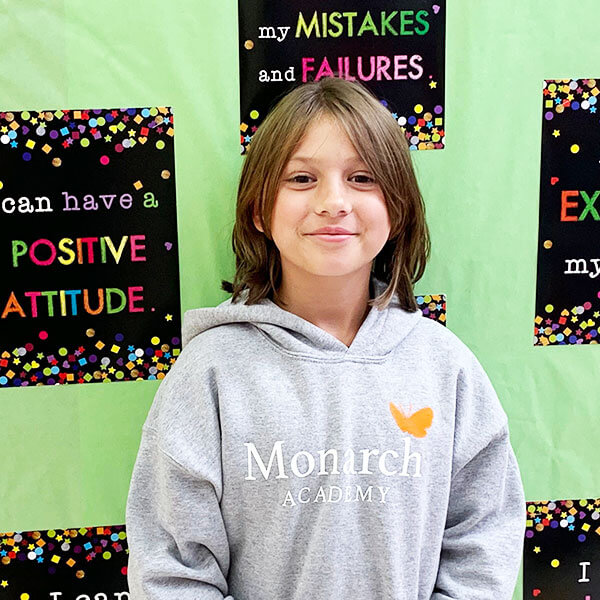 student with Monarch Academy sweatshirt on
